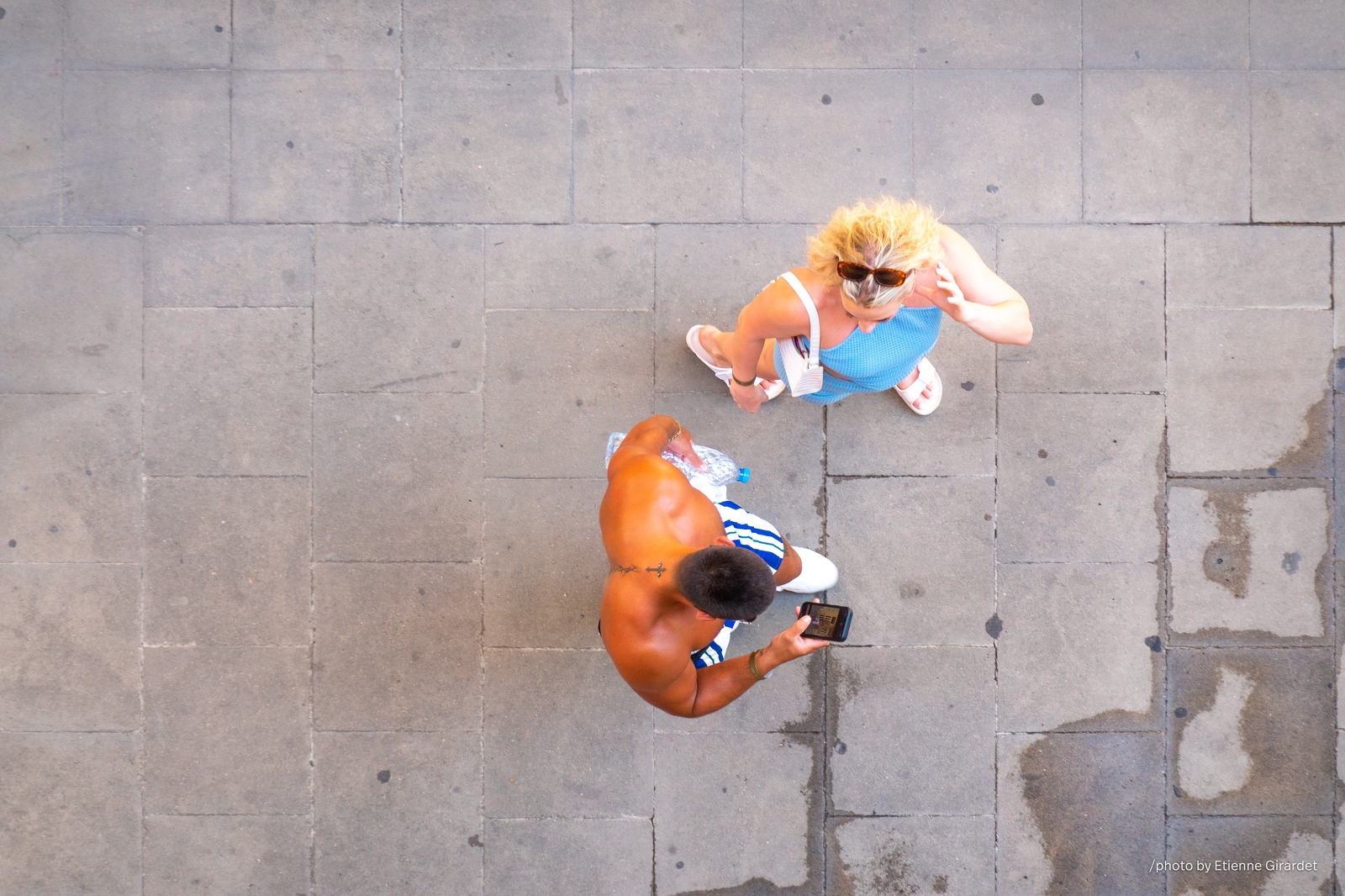 202207_07_RXX01693-two-people-on-paved-street-looking-down-by-E-Girardet.jpg