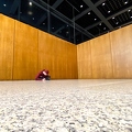 202212_25_IMG_4633-person-sits-writing-on-floor-in-hall-by-E-Girardet.jpg