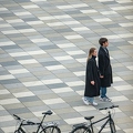 202304_16_RXX03047-couple-walks-on-patterned-pavement-with-bikes-by-E-Girardet.jpg